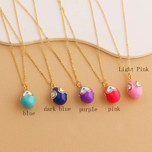 Detailed macro shot of various colorful evil eye heart pendants on gold chain necklaces