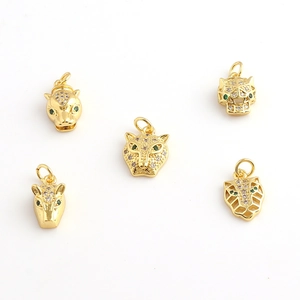 Detailed view of leopard head pendants with 18k gold plating and micro-set cubic zirconia