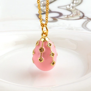 Pink enamel egg pendant necklace in 18k gold plated copper with sparkling crystals
