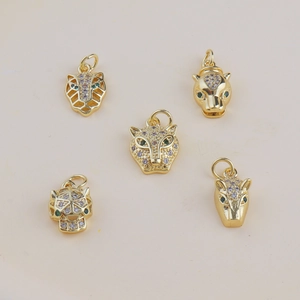 Detailed macro view of 18k gold plated leopard head charms with inlaid sparkling zircons