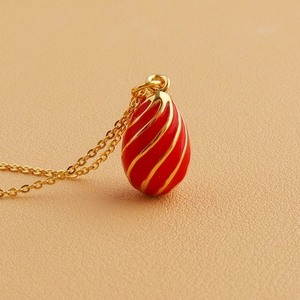 Luxurious vintage 18k gold plated necklace with a red enamel egg-shaped pendant