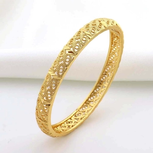Dettaglio di un bracciale placcato oro 24K con intricati motivi geometrici traforati