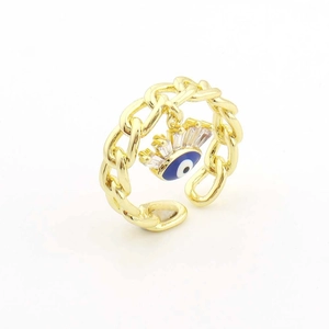 Détail d'une bague chaîne gourmette dorée ajustable avec breloque œil bleu et zircons