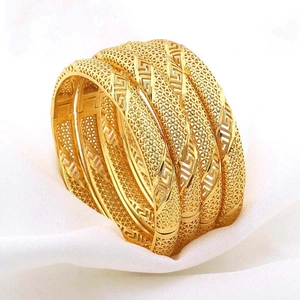 Detail van vier 24K vergulde armbanden met fijne holle Griekse sleutelpatronen