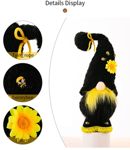 Detail showing knit hat with bow, sunflower and bee accents on plush gnome doll