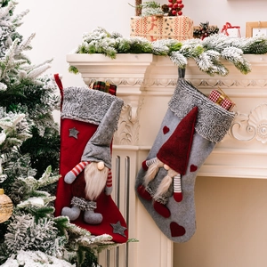 Set of red and grey Christmas stockings with plush 3D gnomes and faux fur trim