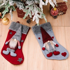Christmas stockings set with Gnome decor and grey faux fur trim on wooden background
