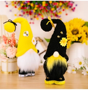Detailed view of handmade bee gnomes with sunflower accents and plush textures