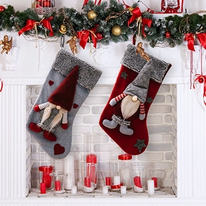 Christmas stockings set with 3D gnome design hanging on a festive fireplace mantel