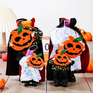 Detail of four Halloween faceless ghost figurines with capes and orange pumpkin lanterns