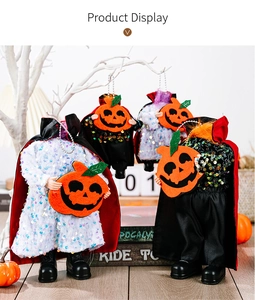 Detail of four headless devil dolls with sequin robes and pumpkins for Halloween decor