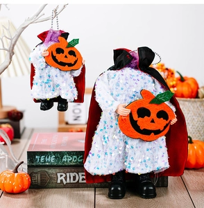 Close-up of headless vampire pumpkin figurines with sequins and bead chain details