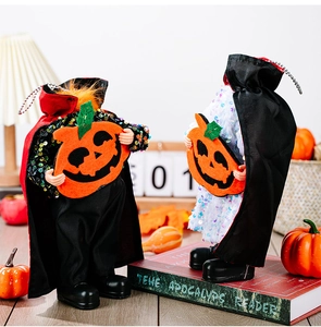 Detail of sequined vampire and ghost ornaments holding pumpkins for Halloween decor