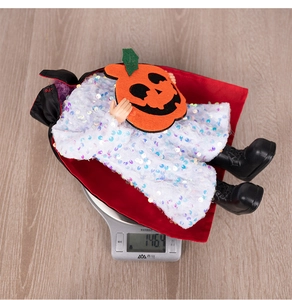 Detail shot of a Halloween vampire doll weighed at 146g featuring a sequined white robe