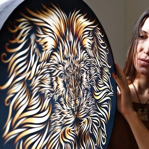 Artistic shaman lion drum with Tree of Life design held by a woman in a home setting