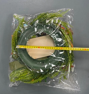 Detail shot of 30cm artificial green fern wreath with purple flowers and measuring tape