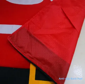 Detailed view of the anti-slip backing and plush Santa belt design on a bathroom mat