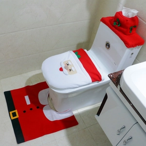 Detail view of red Santa Claus toilet lid cover and matching bath mat set for bathroom