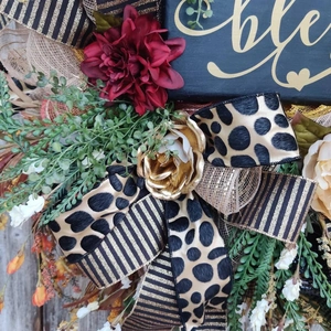 Autumn wreath with red dahlia, golden roses and black gold striped decorative ribbons