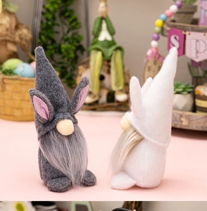 Close-up of Easter rabbit gnomes with soft fur and bunny ears on a festive table
