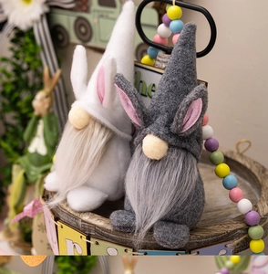 Detail of plush Easter bunny gnomes on wood tray with soft velvet hats and long faux fur beards