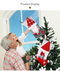 Family hanging decorative felt Christmas stockings with gnomes on a festive Xmas tree