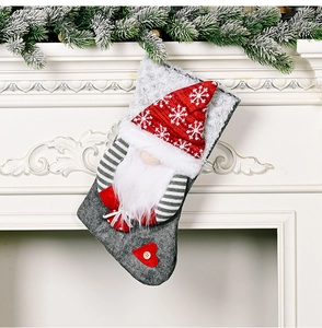 Close-up of a festive gnome Christmas stocking hanging on a white fireplace mantle