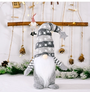 Detailed view of a grey Christmas gnome plush with snowflake patterns and cozy lighting