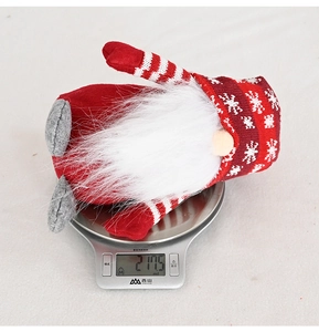 Christmas gnome plush on a digital scale weighing 217.5g with snowflake knit hat