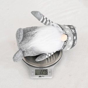 Detail shot showing the weight measurement of a gray knitted gnome Christmas decoration