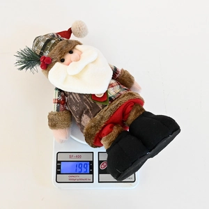 Close-up of a Santa plush toy on a digital scale showing weight of 199 grams