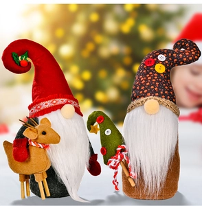 Detail of Christmas gnomes holding a felt reindeer with festive plush fabrics and warm lighting