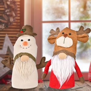 Detailed view of snowman and reindeer faceless dolls with antlers and velvet fabric