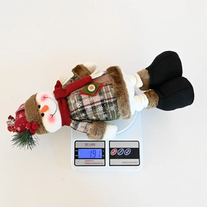 Detail view of snowman plush on a digital scale showing a weight of 191 grams