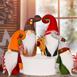 Set of Christmas gnome plush dolls and reindeer ornaments on white display stands