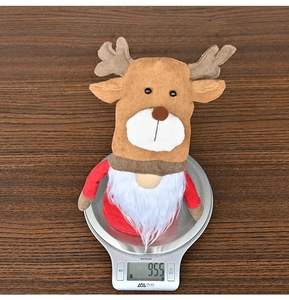 Detailed view of a Christmas reindeer gnome ornament weighing 95.5g on a scale