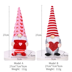 Pair of Valentine's Day gnomes with pink heart hat and red envelope decorations