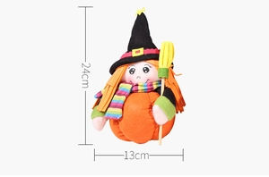 Detail view of a 24cm plush Halloween witch doll with orange hat and broomstick