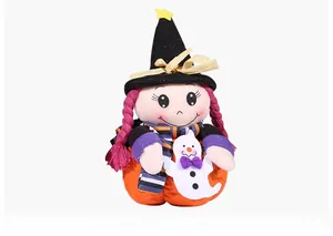 Detail of Halloween witch plush with pumpkin body holding a ghost and wearing a black hat