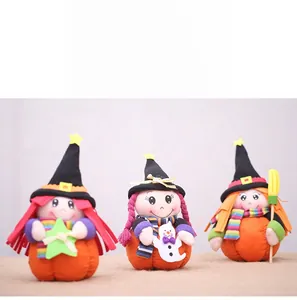 Three Halloween plush witch dolls on pumpkin bases with broom and ghost props