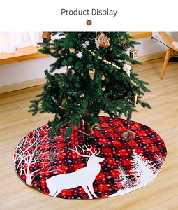 Detail of red and black buffalo plaid Christmas tree skirt with white elk and snowflake print
