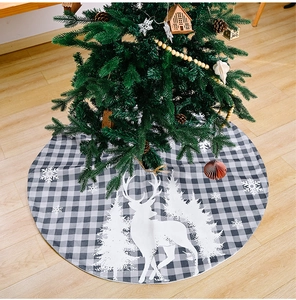 Detailed view of grey and white plaid Christmas tree skirt with reindeer pattern