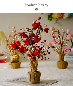 Detail of tulip tree centerpiece with LED lights, pearls, and a rustic burlap base