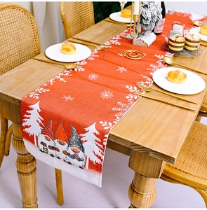 Detailed Christmas table runner with red cotton linen, white snowflakes and gnome prints