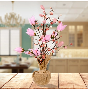 Detail of tulip decorative tree with pink flowers, hearts and warm burlap base for desk