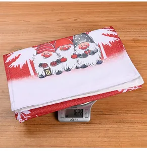 Macro detail of Christmas gnome table runner with forest print on rustic wooden surface