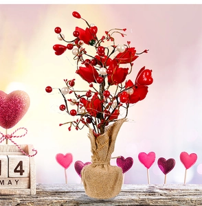 Detailed view of artificial rose tree with heart ornaments and burlap base decoration