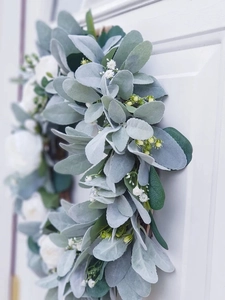Detail of white roses and lamb's ear leaves on a handcrafted decorative floral wreath