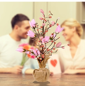 Detail of tulip tree decoration with pink fabric buds, hearts and burlap base