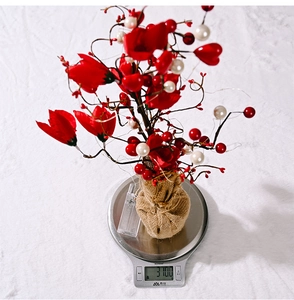 Detailed weight display of tulip LED decorative tree at 310g on a digital scale